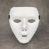 A white, smooth masquerade mask with a stylized face and black ear loops is displayed on a gray surface.