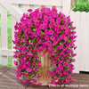 A dense display of vibrant pink artificial morning glory hanging vines in a white planter