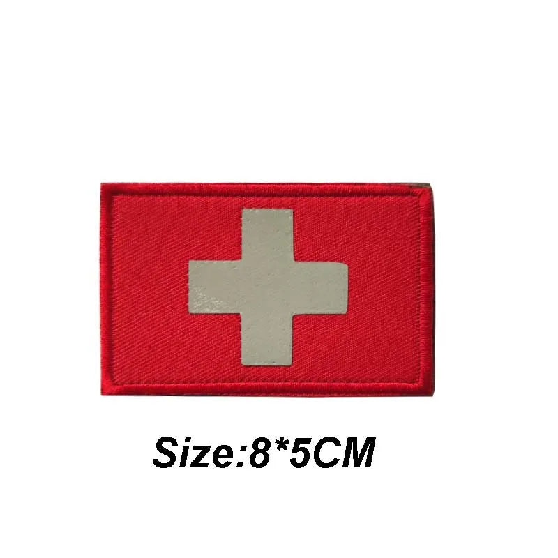 Red tactical morale patch with a silver cross symbol