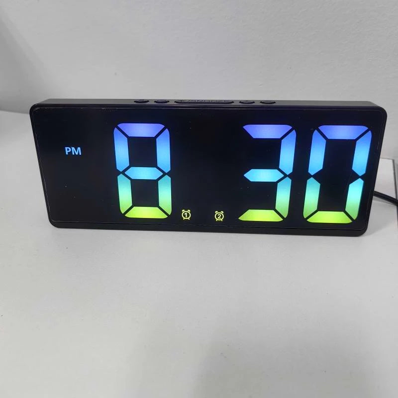 A black digital alarm clock displaying 8:30 PM with a blue LED screen.