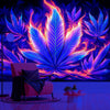 A vibrant neon cannabis leaf tapestry hangs on a wall above a pink armchair.