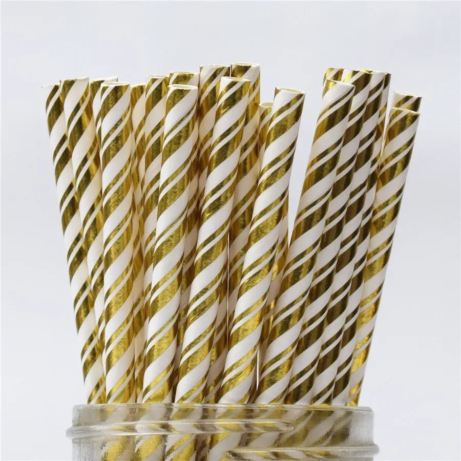 A bundle of gold and white striped paper drinking straws