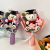 A handcrafted crochet flower bouquet featuring a teddy bear wearing a graduation cap and gown.