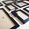 A set of black picture frames with clear plexiglass, showing various sizes and a measurement guide.