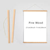A vertical wooden art frame with a white mat displaying the text Pine Wood