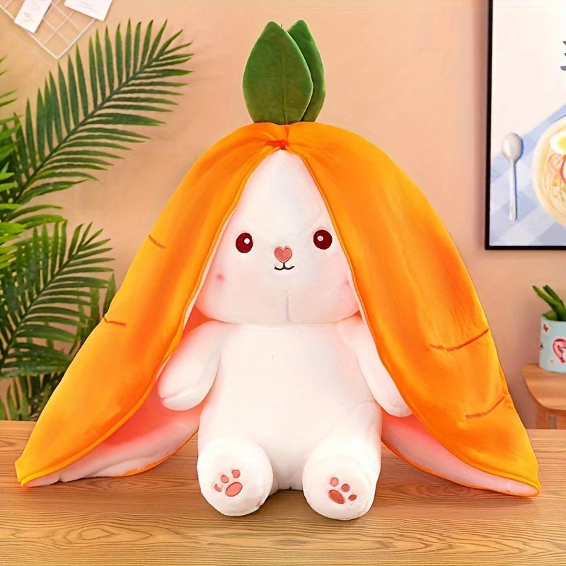 A white bunny plush toy with bright orange ears and body, sitting on a wooden surface.