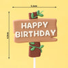 Señal de cumpleaños de madera con el texto 'HAPPY BIRTHDAY' y hojas de dinosaurio verdes, montada en un palo.