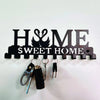 Black metal key holder with wall mounted hooks featuring the initials H&ME and the text Sweet Home