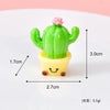 A small green cactus with a pink flower growing out of a yellow pot, used as a resin charm.