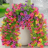 A vibrant archway made of artificial flowers in shades of pink, purple, yellow, and green.