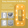 A yellow marquee letter frame with a mirror and lights, along with included parts and instructions.