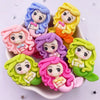 A collection of colorful resin figurines depicting mermaid princesses with curly hair and delicate features.