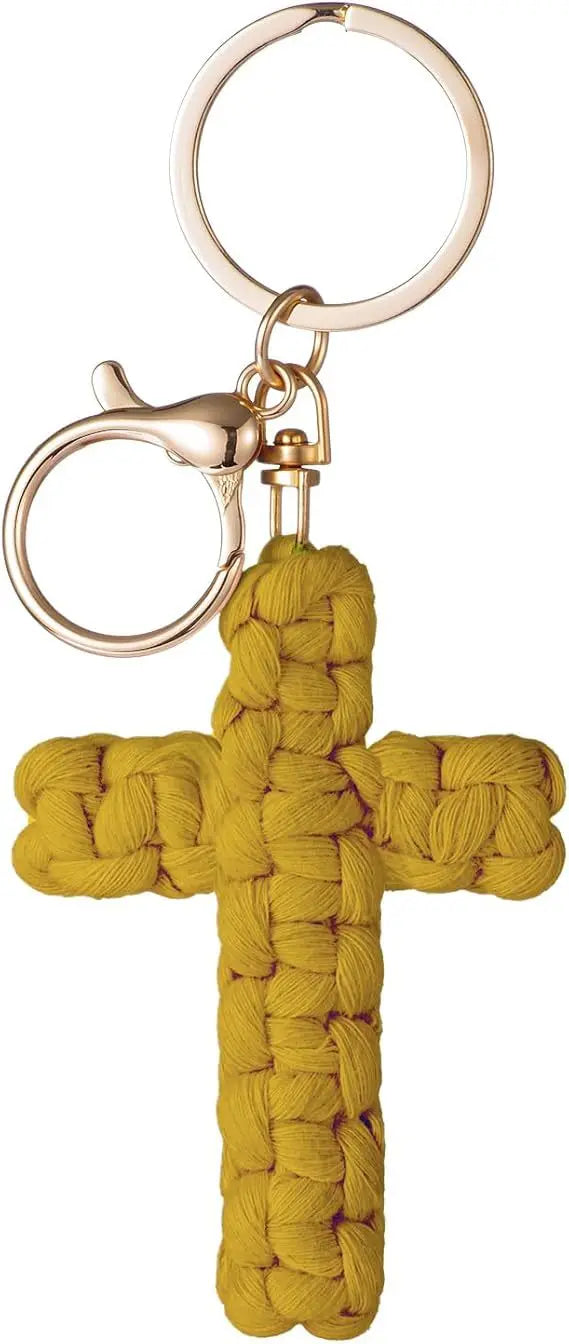 A golden woven cross keychain with a circular split ring attached.