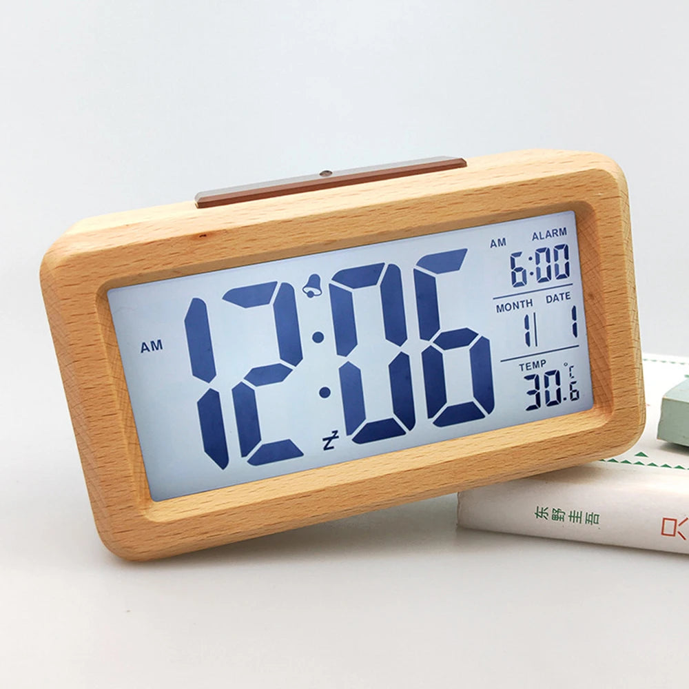A light wood digital alarm clock displaying 12:06 AM, with features for time, date, and temperature.
