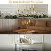 A set of three vintage European style metal candle holders displayed on a white mantelpiece.