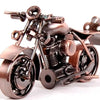 A handcrafted metal motorcycle model with a vintage appearance, featuring dark bronze and black components.