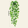 A vertical display of realistic green artificial ivy vines used for indoor and outdoor decoration.