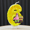 A yellow sponge cake shaped like the number 6, decorated with characters from SpongeBob SquarePants.