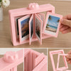 A pink 3D rotating photo frame for desk display showing various photos.