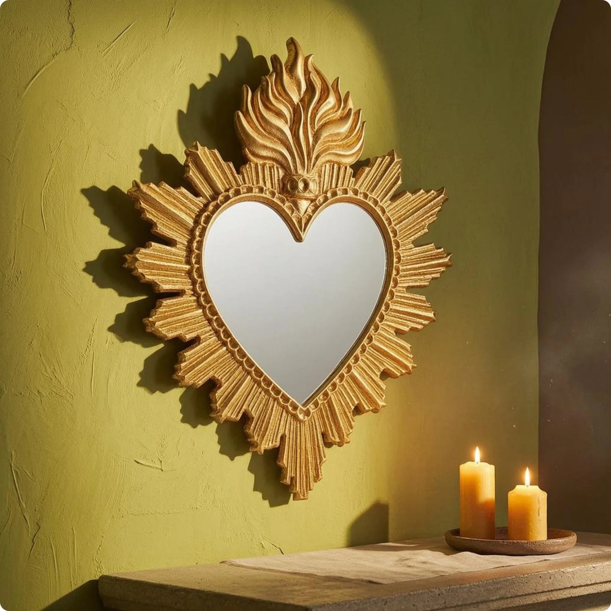 Ornate gold-framed heart-shaped wall mirror with a flame design mounted on a lime green textured wall.