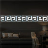 A horizontal acrylic mirror wall sticker set featuring a geometric maze pattern mounted on a dark gray wall.