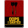 A vintage metal sign with a red background and a target design, featuring the text OOPS I DARTED.