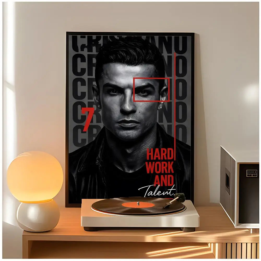 A poster featuring a close-up portrait of Cristiano Ronaldo with red accents, displayed on a wooden table.