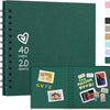 A dark green spiral-bound notebook with a heart design and several photo pockets for scrapbooking.