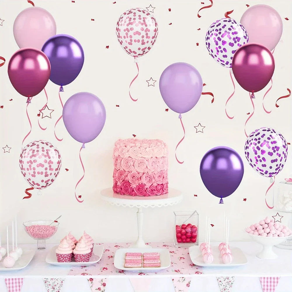A display of pink and purple latex balloons, confetti, and macarons arranged for a party set.