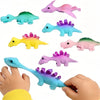 Colorful dinosaur slingshot flying toys for kids party favors and prizes shown in various colors
