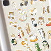 A collection of cute cat stickers featuring various poses and expressions on a light-colored phone case.