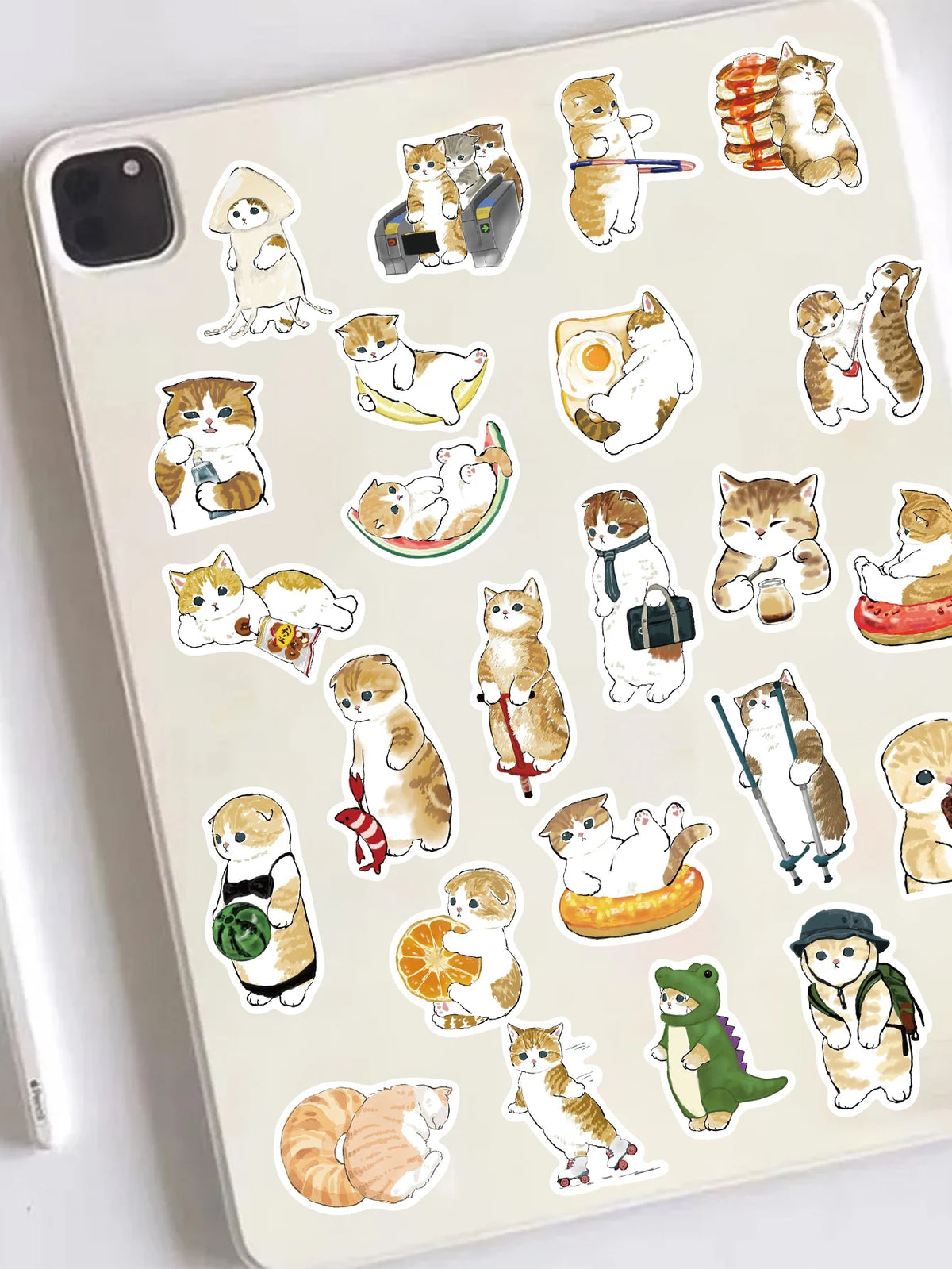 A collection of cute cat stickers featuring various poses and expressions on a light-colored phone case.