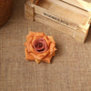 An orange rose flower rests on a burlap surface next to a wooden box labeled Wooden Box.