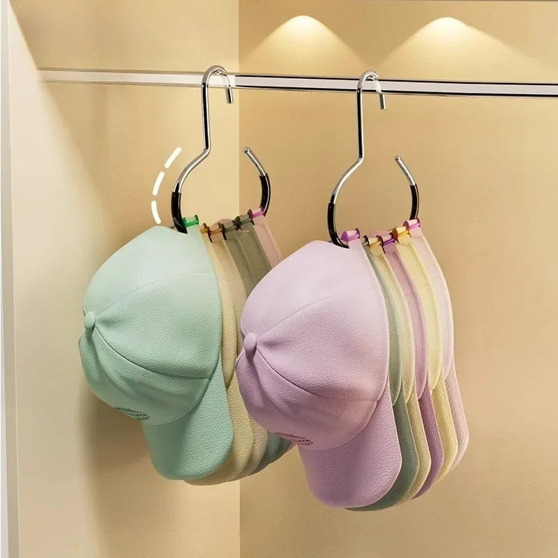 A display of various colored circle ring hats hanging on a metal rack.
