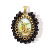 A gold-toned pendant featuring a clear oval charm surrounded by dark brown beads and a bail.