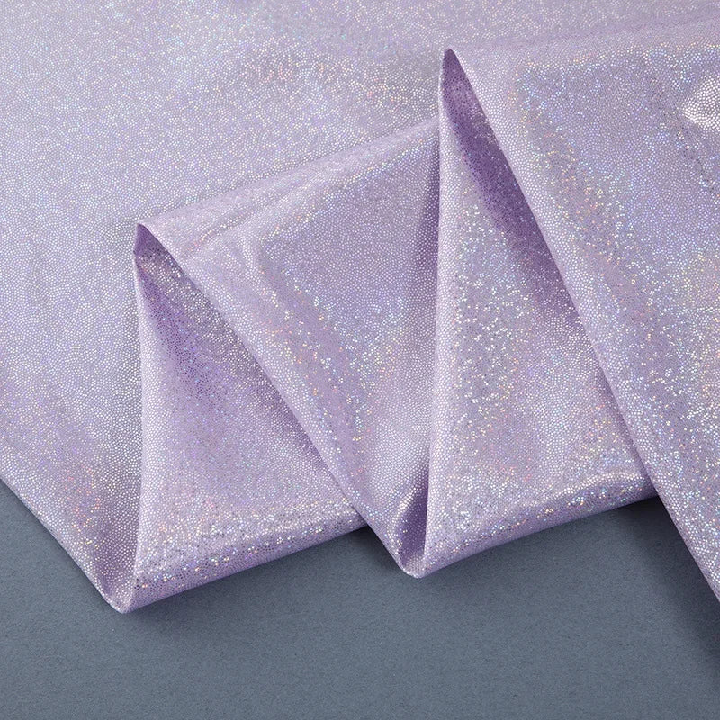 Purple sequin backdrop curtain fabric folded to show texture and shimmer