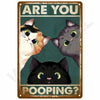 A vintage metal wall sign featuring three cats asking Are You Pooping?