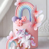 Pink unicorn theme cake topper set featuring a rainbow arch and pink butterfly decorations