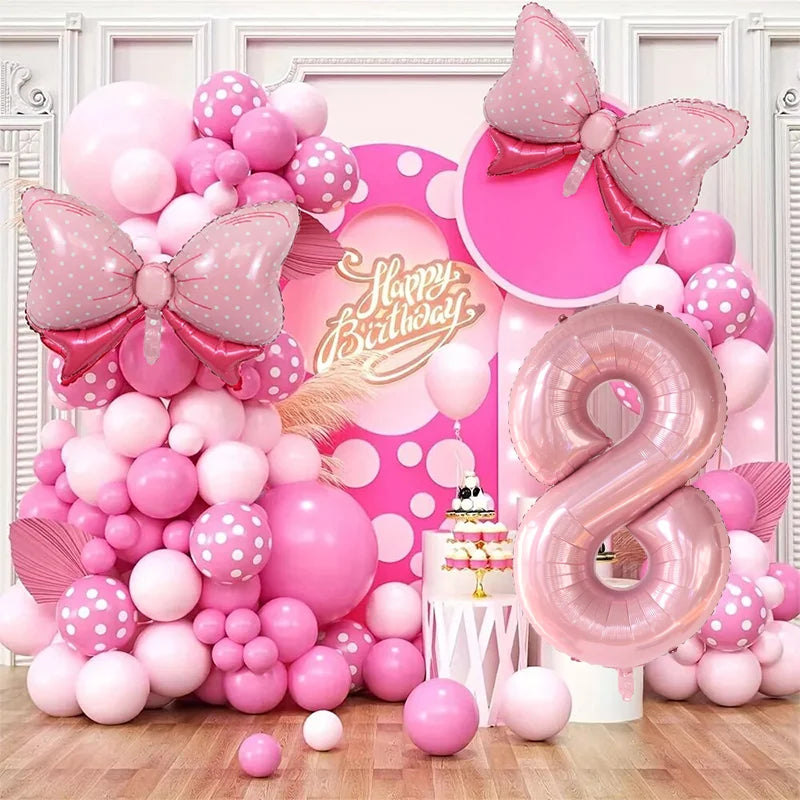 A pink and white balloon garland arch kit featuring numerous balloons in various shades of pink and white.