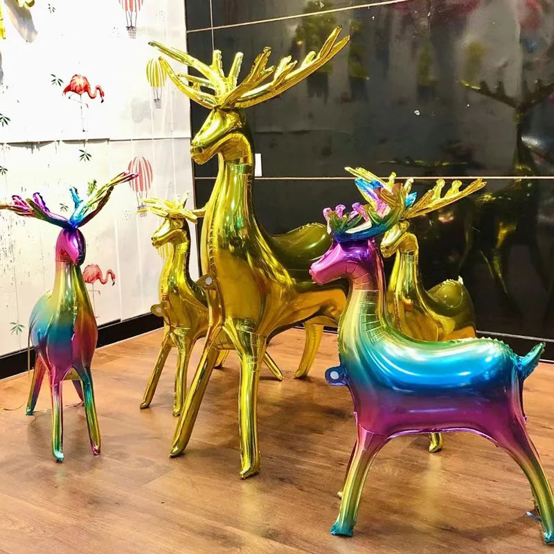 A set of two foil balloons shaped like deer in iridescent gold and purple colors.