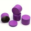 A set of purple metal candle tins with matching lids, shown in various angles.