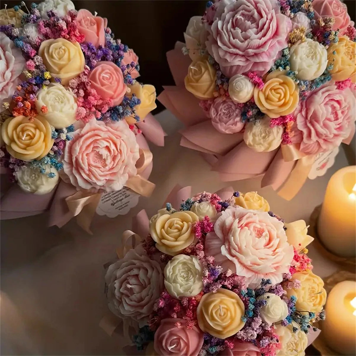 A collection of floral silicone candle molds featuring pink, yellow, and white rose, peony, and camellia shapes.