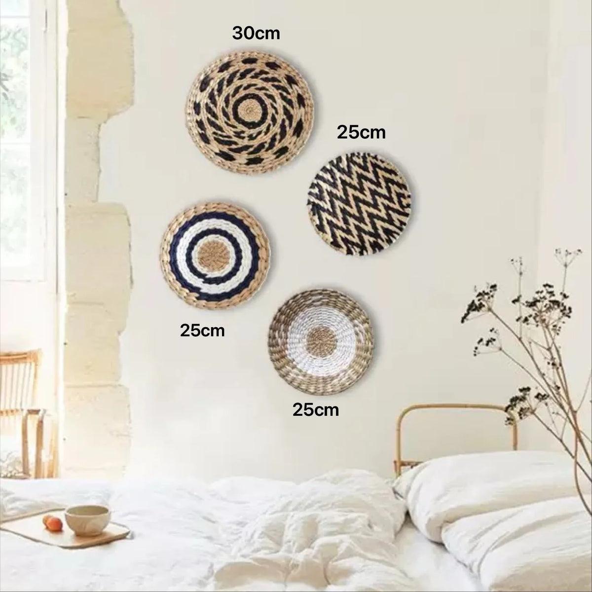 A collection of round boho straw wall hangings in various sizes and patterns displayed on a light-colored wall.