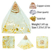 A clear quartz pyramid crystal with a copper screw and gold foil accents.