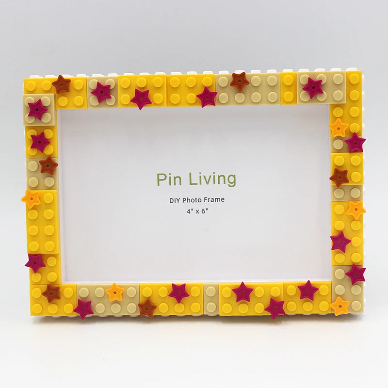 A yellow and pink block photo frame decorated with star shapes, ready for DIY photo display.
