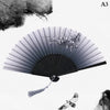 A black and white image of a hand carved bamboo folding fan with delicate floral accents.