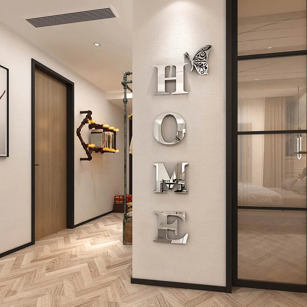 A wall display featuring metallic letters H O M F arranged in a vertical line on a light-colored wall.