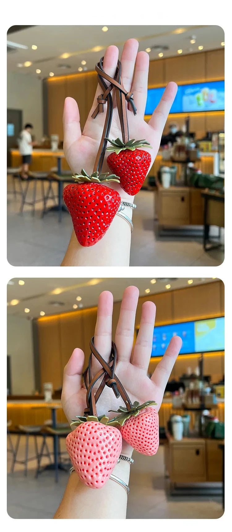 A hand holds a bright red strawberry charm and keychain against a blurred background of a modern cafe.
