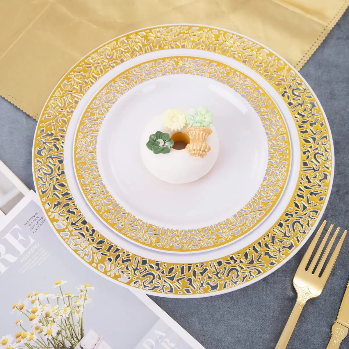 Elegant gold rim plastic dinner and dessert plate set with a white plate and small floral garnish