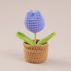 Handcrafted crochet purple tulip flower growing in a brown woven pot